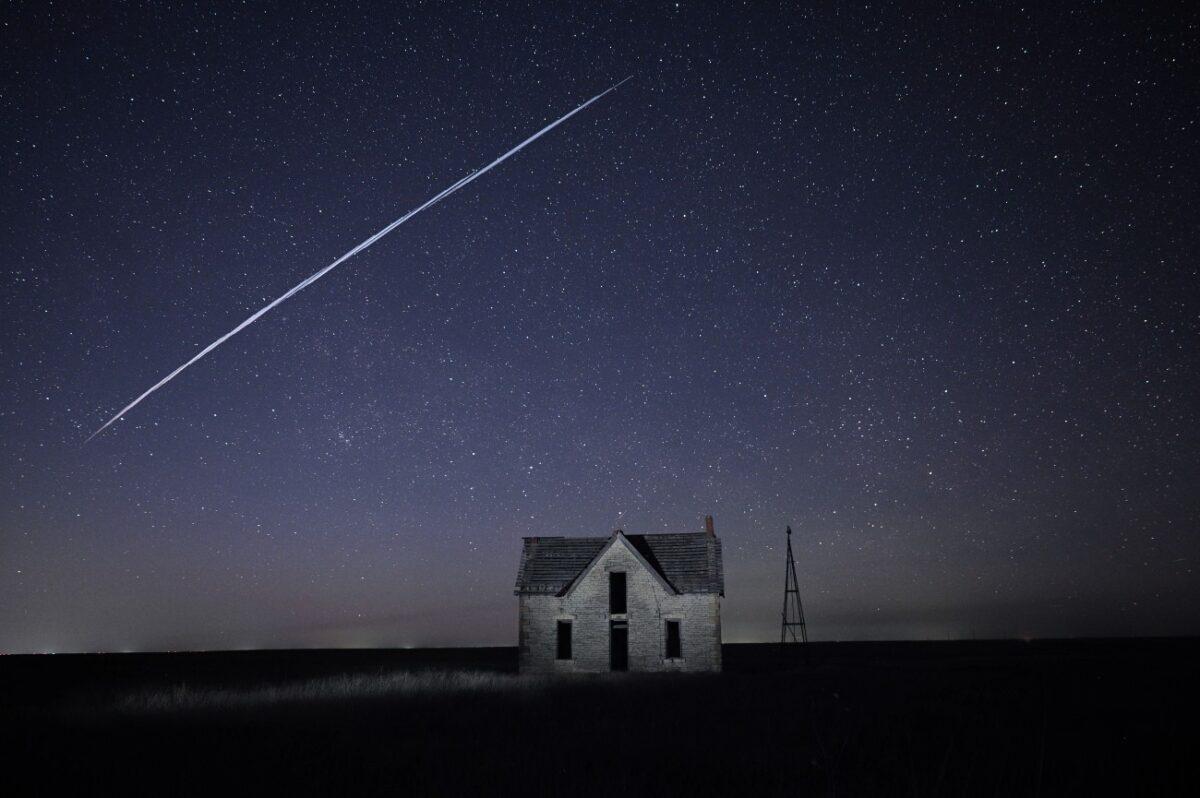 A string of SpaceX StarLink satellites passes over an old stone house near Florence, Kan., on May 6, 2021. (Reed Hoffmann/AP Photo)