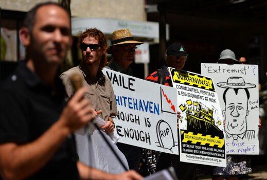 Protesters hold placards during a rally against Whitehaven Coal in Sydney on February 20, 2014. (Saeed Khan/AFP via Getty Images)