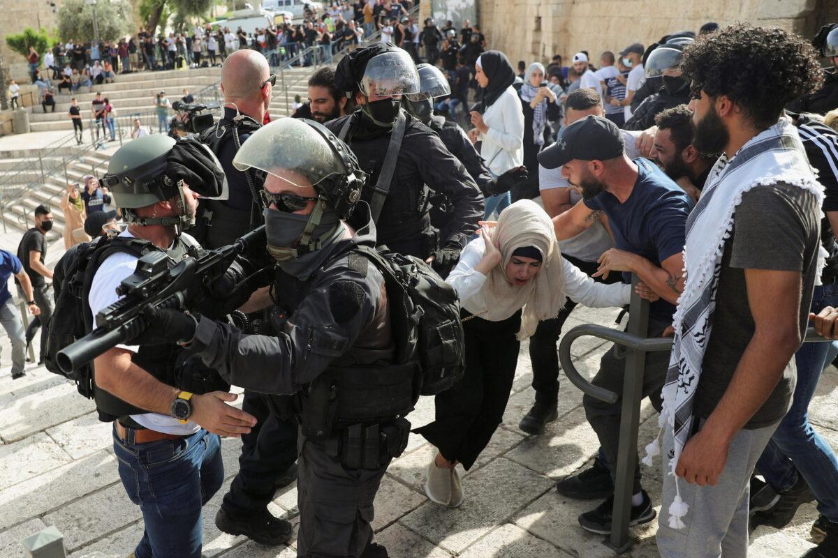 A Palestinian woman reacts during scuffles with Israeli security force members amid Israeli-Palestinian tension as Israel marks Jerusalem Day, near Damascus Gate in Old City, Jerusalem, on May 10, 2021. (Ronen Zvulun/Reuters)