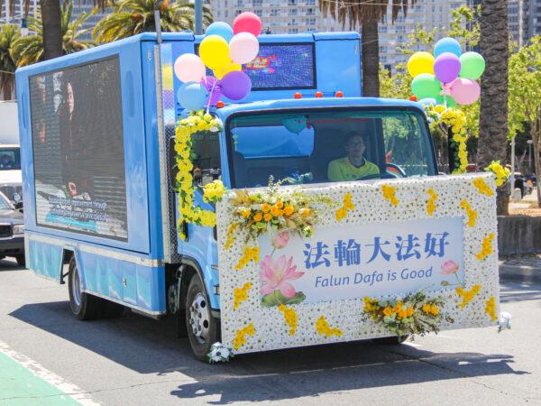 Dan Ngo drives his truck in a parade to celebrate World Falun Dafa Day in San Francisco on May 8, 2021. (David Lam/The Epoch Times)