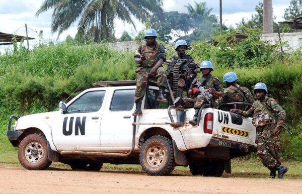 Blue-helmeted members of the United Nations Organization Stabilization Mission in the Democratic Republic of the Congo sit on the back of a U.N. pickup truck in Beni, Democratic Republic of the Congo, on Oct. 23, 2014. (Alain Wandimoyi /AFP via Getty Images)