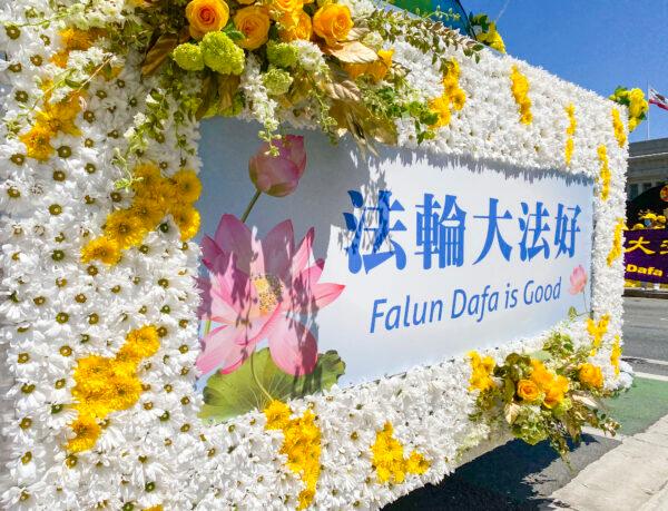 The sign on the front of a truck is decorated with real flowers for the parade to celebrate World Falun Dafa Day in San Francisco on May 8, 2021. (Ilene Eng/The Epoch Times)