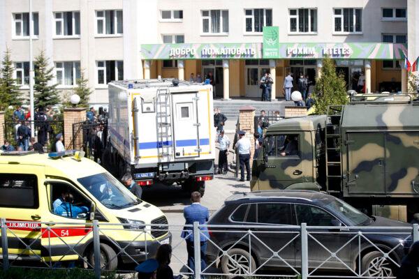 An ambulance and police trucks are parked at a school after a shooting in Kazan, Russia, on May 11, 2021. (Roman Kruchinin/AP Photo)