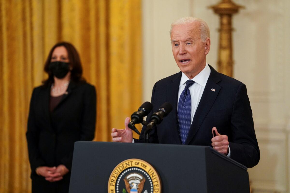President Joe Biden delivers remarks as Vice President Kamala Harris stands by in the East Room at the White House in Washington on May 10, 2021. (Kevin Lamarque/Reuters)