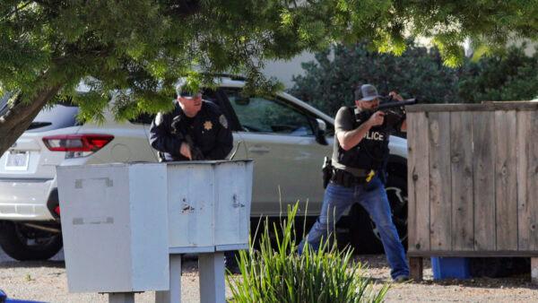 Officers take aim at an apartment across Camilla Court in San Luis Obispo, Calif., on May 10, 2021. (David Middlecamp/The Tribune (of San Luis Obispo) via AP)