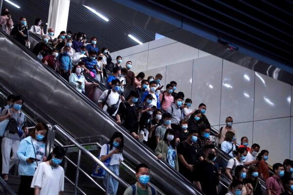 People walk at a subway station in Shanghai, China, on May 11, 2021. (Aly Song/Reuters)