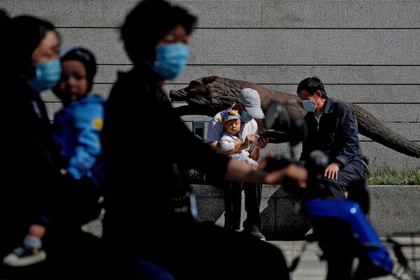 People outside a shopping mall in Beijing on May 8, 2021. (AP Photo/Andy Wong)