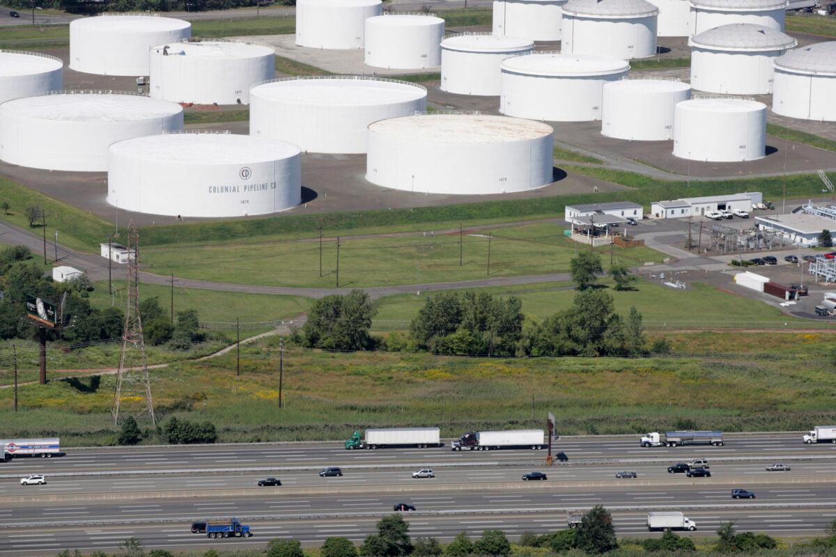Traffic on I-95 passes oil storage tanks owned by the Colonial Pipeline Company in Linden, N.J., in a file photograph. (Mark Lennihan/AP Photo)