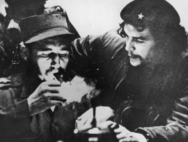 Cuban revolutionary Fidel Castro (left) lights a cigar while Argentine revolutionary Che Guevara looks on in the early days of their guerrilla campaign in the Sierra Maestra Mountains of Cuba, circa 1956. (Hulton Archive/Getty Images)