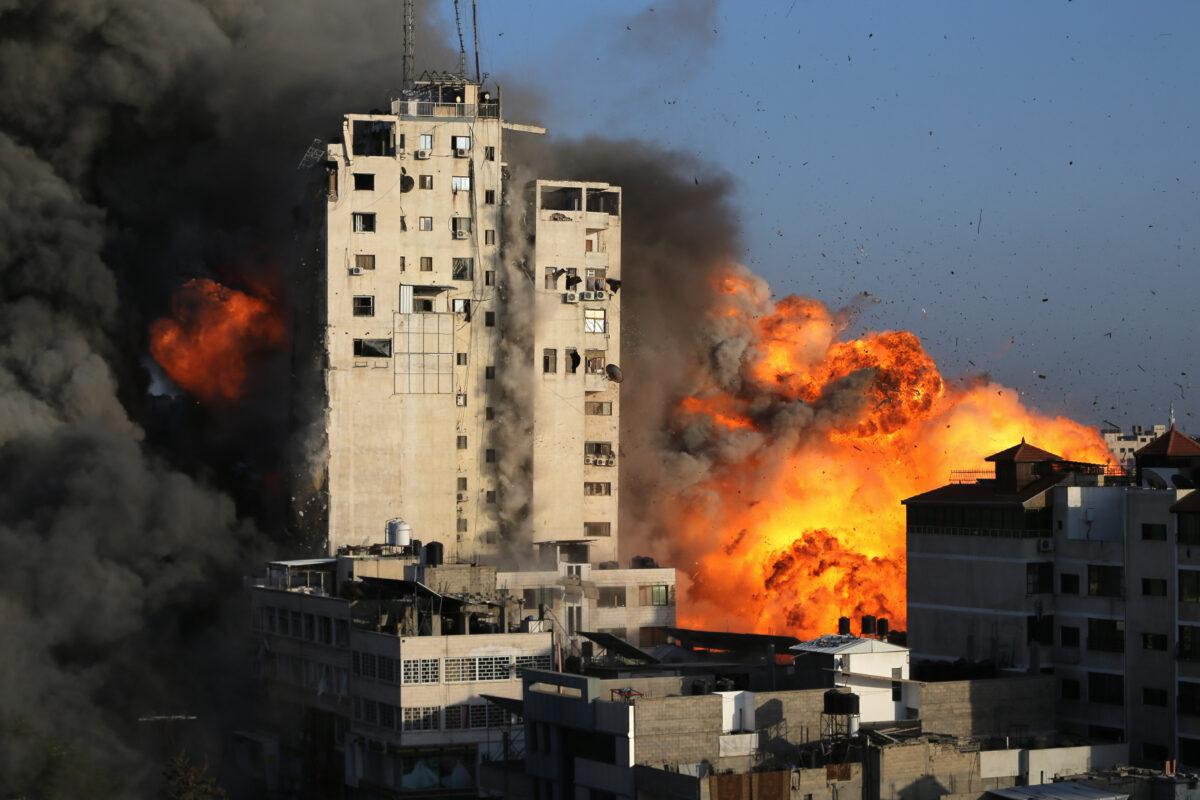Smoke and flames rise from a tower building as it is destroyed by Israeli airstrikes amid a flare-up of Israeli-Palestinian violence, in Gaza City, on May 12, 2021. (Ibraheem Abu Mustafa/Reuters)