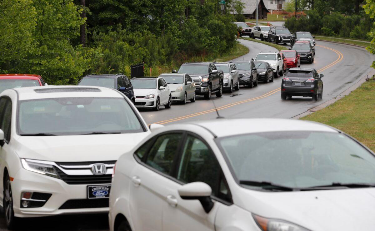 Cars line up on Pine Plaza Drive for gas at the Costco in Apex, N.C., on May 12, 2021. (Ethan Hyman/The News & Observer via AP)