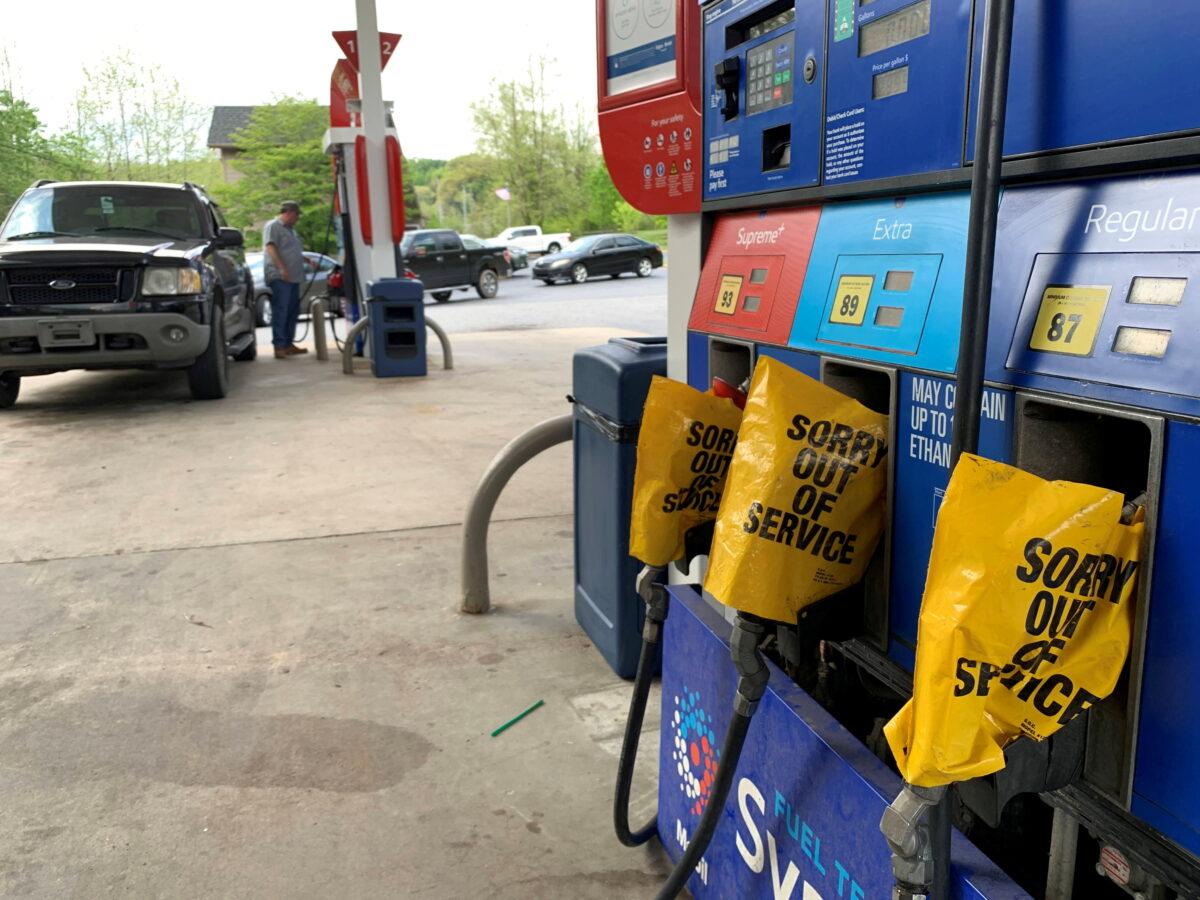 Out of service fuel nozzles are covered in plastic on a gas pump at a gas station in Waynesville, N.C., on May 11, 2021. (Martin Brossman via Reuters)