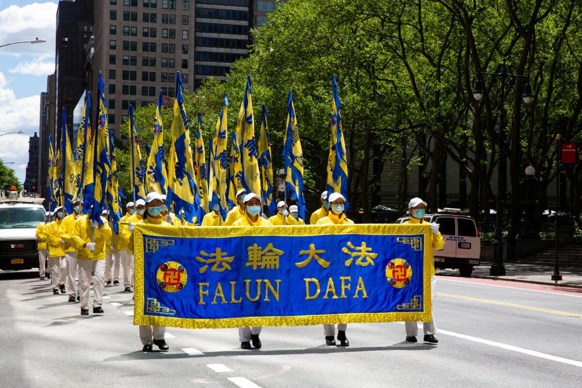 Practitioners of the spiritual discipline Falun Gong hold a parade in New York City on May 13, 2021. (Chung I Ho/The Epoch Times)