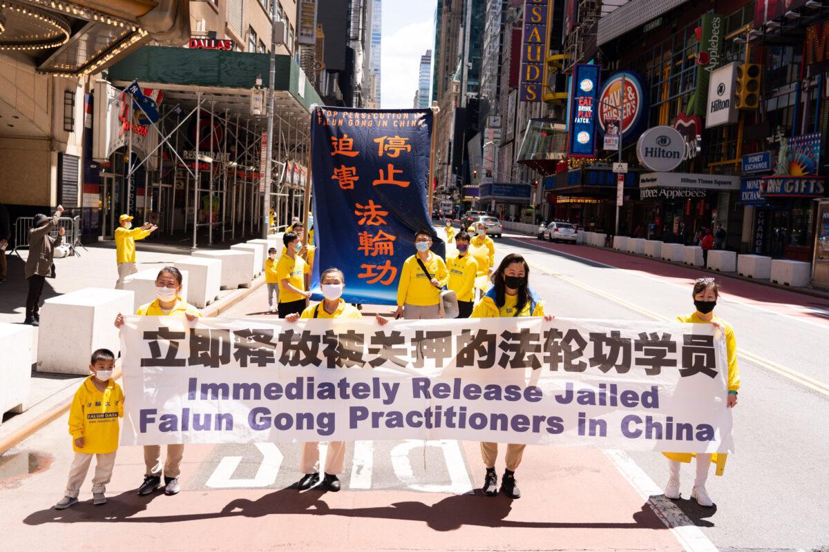 Practitioners of the spiritual discipline Falun Gong hold a parade in New York City on May 13, 2021. (Larry Dai/The Epoch Times)