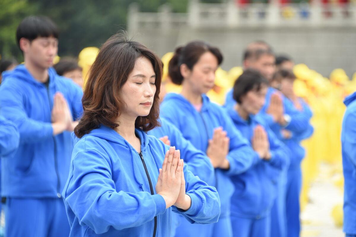 Falun Gong practitioners perform exercises at an event celebrating World Falun Dafa Day in Taipei, Taiwan, on May 1, 2021. (Sun Hsiang-yi/The Epoch Times)