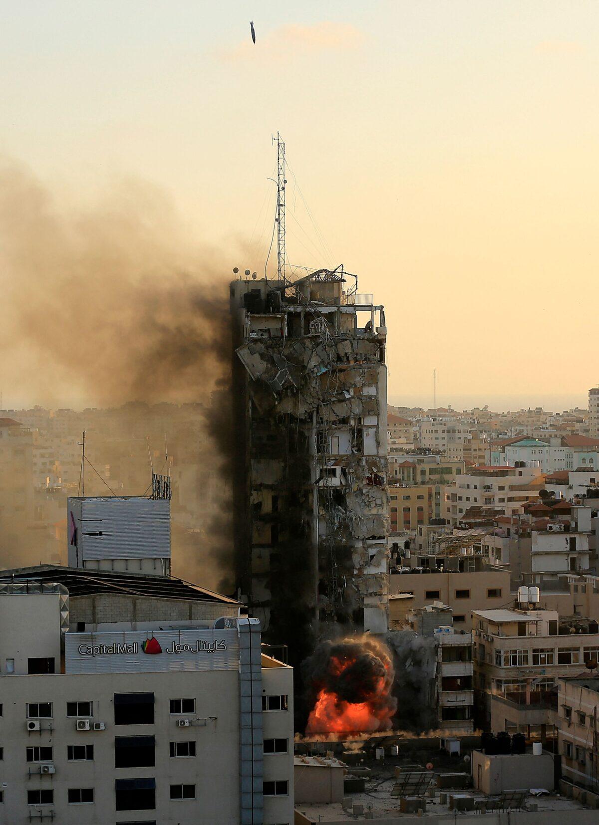 An air-guided bomb can be seen hitting Al-Sharouk tower in Gaza City on May 12, 2021. (Qusay Dawud/AFP via Getty Images)