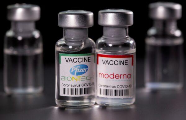 Vials with Pfizer-BioNTech and Moderna COVID-19 vaccine labels are seen in this illustration picture taken March 19, 2021. (Dado Ruvic/File Photo/Reuters)