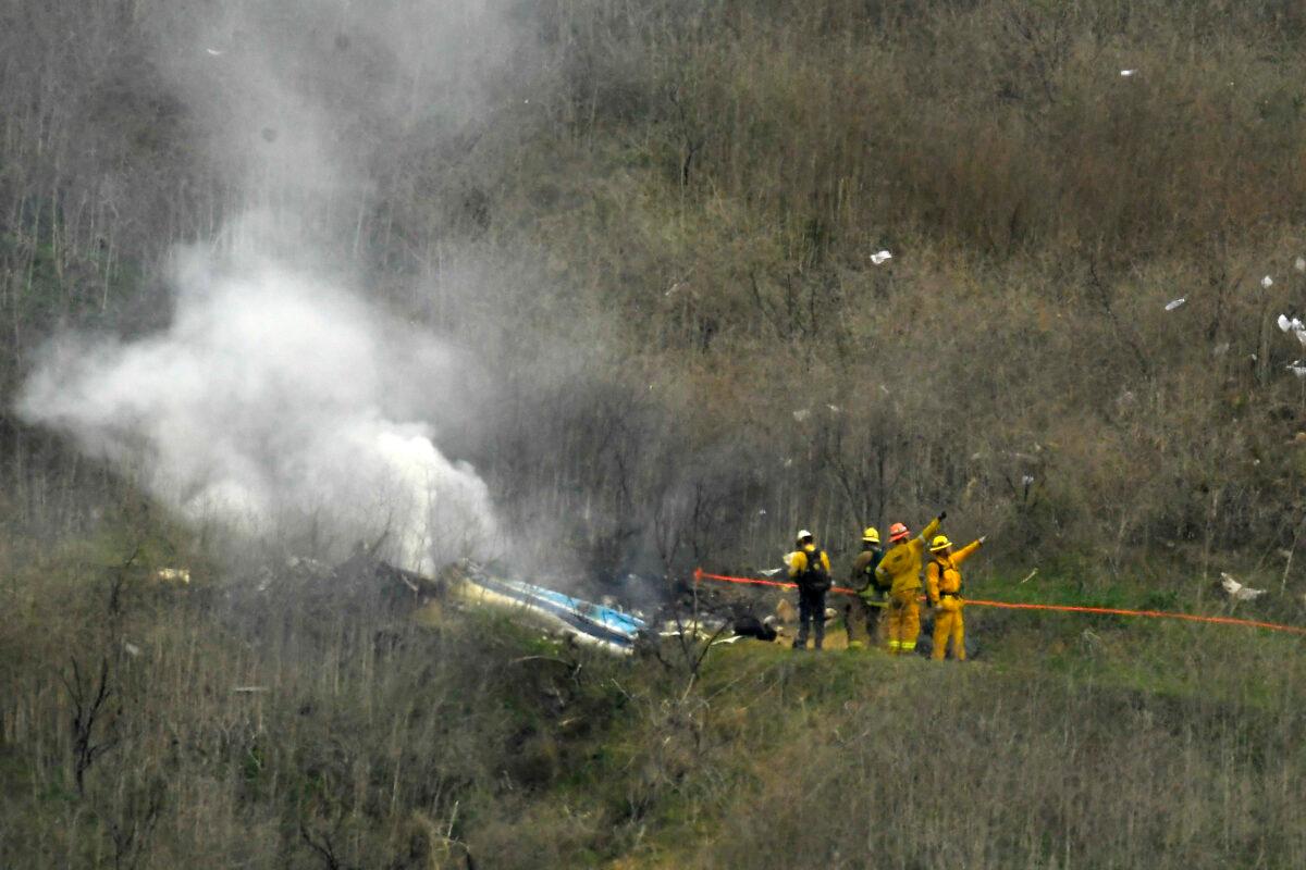 Firefighters work the scene of a helicopter crash where former NBA basketball star Kobe Bryant died, in Calabasas, Calif., on Jan. 26, 2020. (Mark J. Terrill/AP Photo)