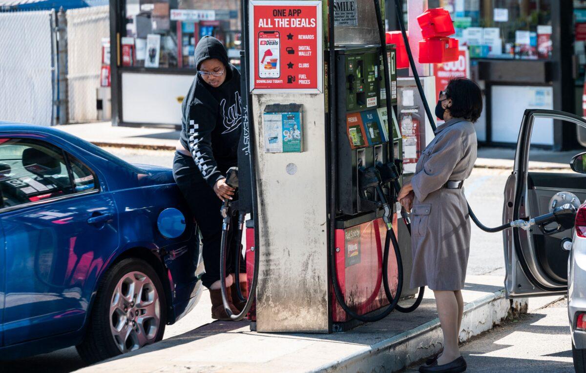 People fill their cars with gas in Arlington, Va., on May 13, 2021. (Andrew Caballero-Reynolds/AFP via Getty Images)