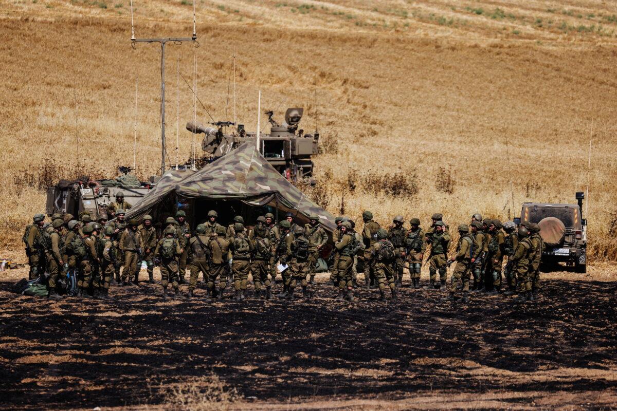 Israeli soldiers of an artillery unit gather near the border between Israel and the Gaza Strip, on its Israeli side, on May 14, 2021. (Amir Cohen/Reuters)