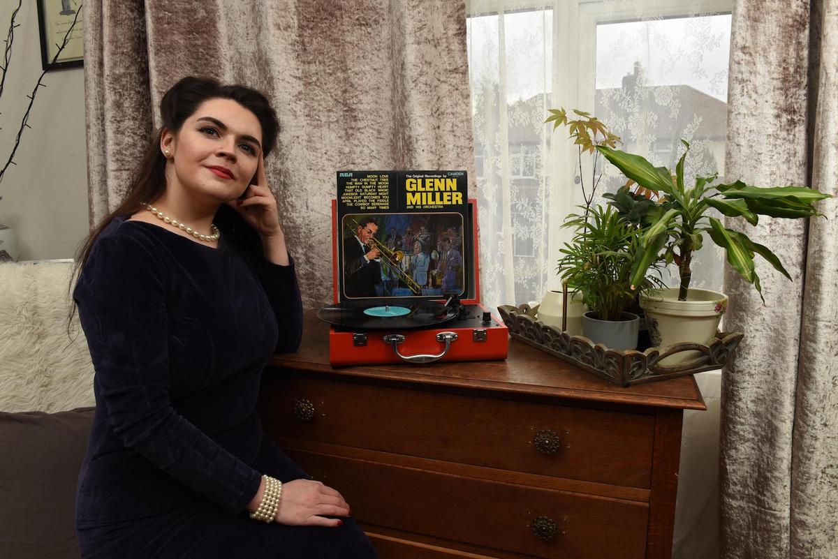Hannah Hall in her home, listening to her records. (Caters News)
