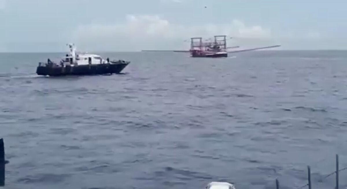A screen grab from a video released by the Philippine Coast Guard shows a Philippine bureau of fisheries vessel (L) approaching another vessel believed to be manned by Chinese militia at Sabina Shoal in the South China Sea, May 7, 2021. (National Task Force on the West Philippine Sea/Philippine Coast Guard/Handout via Reuters)