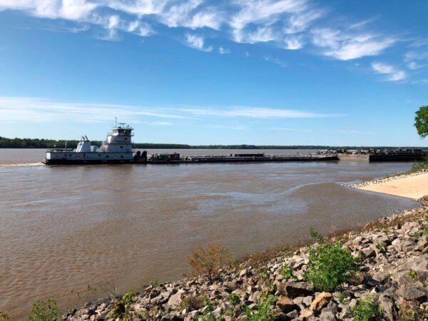 A tugboat with a barge attached sits near a boat ramp at Meeman-Shelby Forest State Park in Millington, Tenn., on May 12, 2021. (Adrian Sainz/AP Photo)