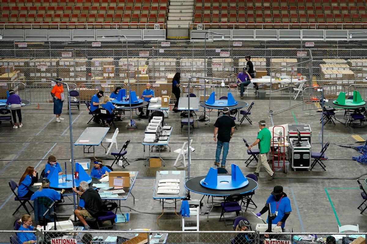 Maricopa County ballots cast in the 2020 general election are examined and recounted by contractors working for Florida-based company, Cyber Ninjas, at Veterans Memorial Coliseum in Phoenix, on May 6, 2021. (Matt York/Pool/AP Photo)