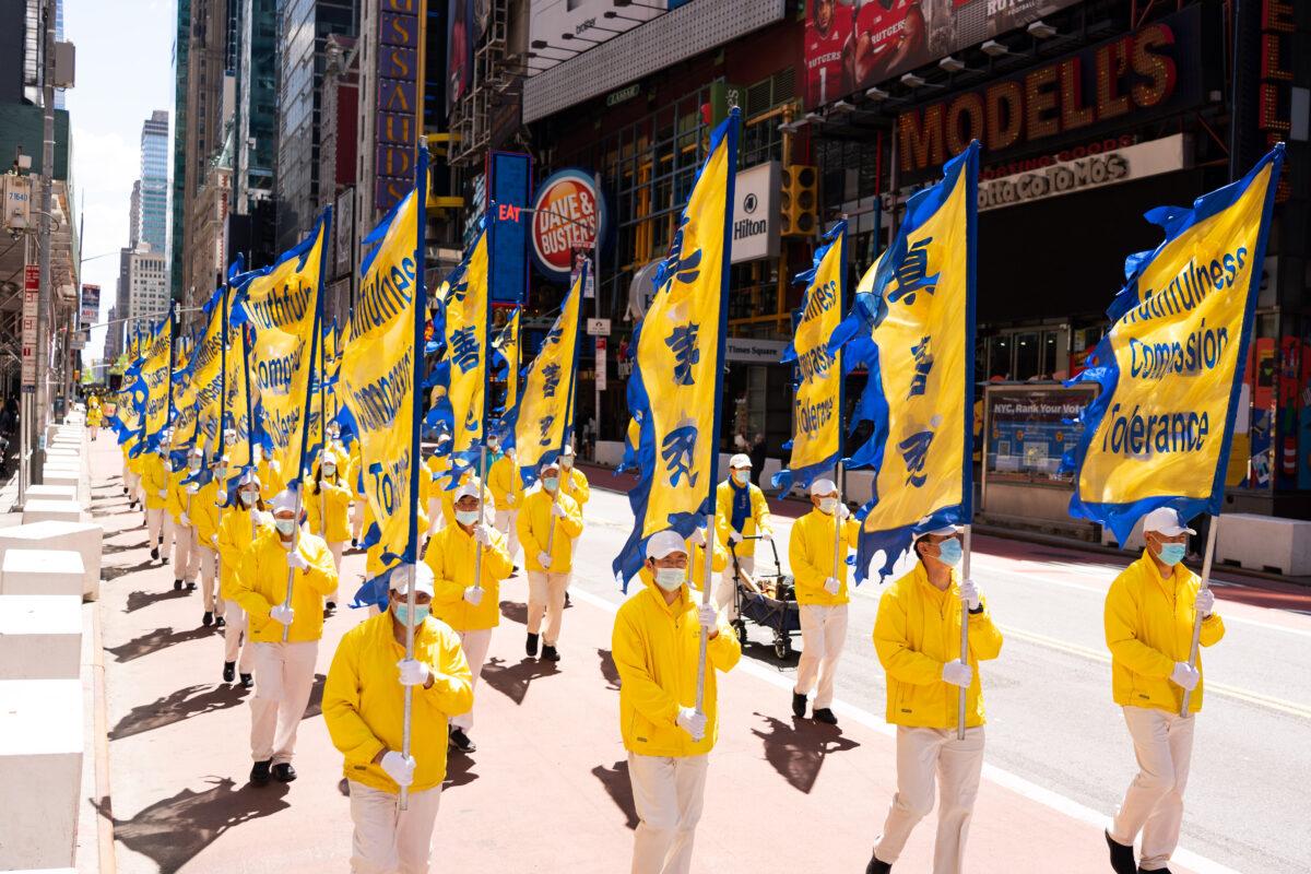 Practitioners of the spiritual discipline Falun Gong hold a parade in New York City on May 13, 2021. (Larry Dai/The Epoch Times)