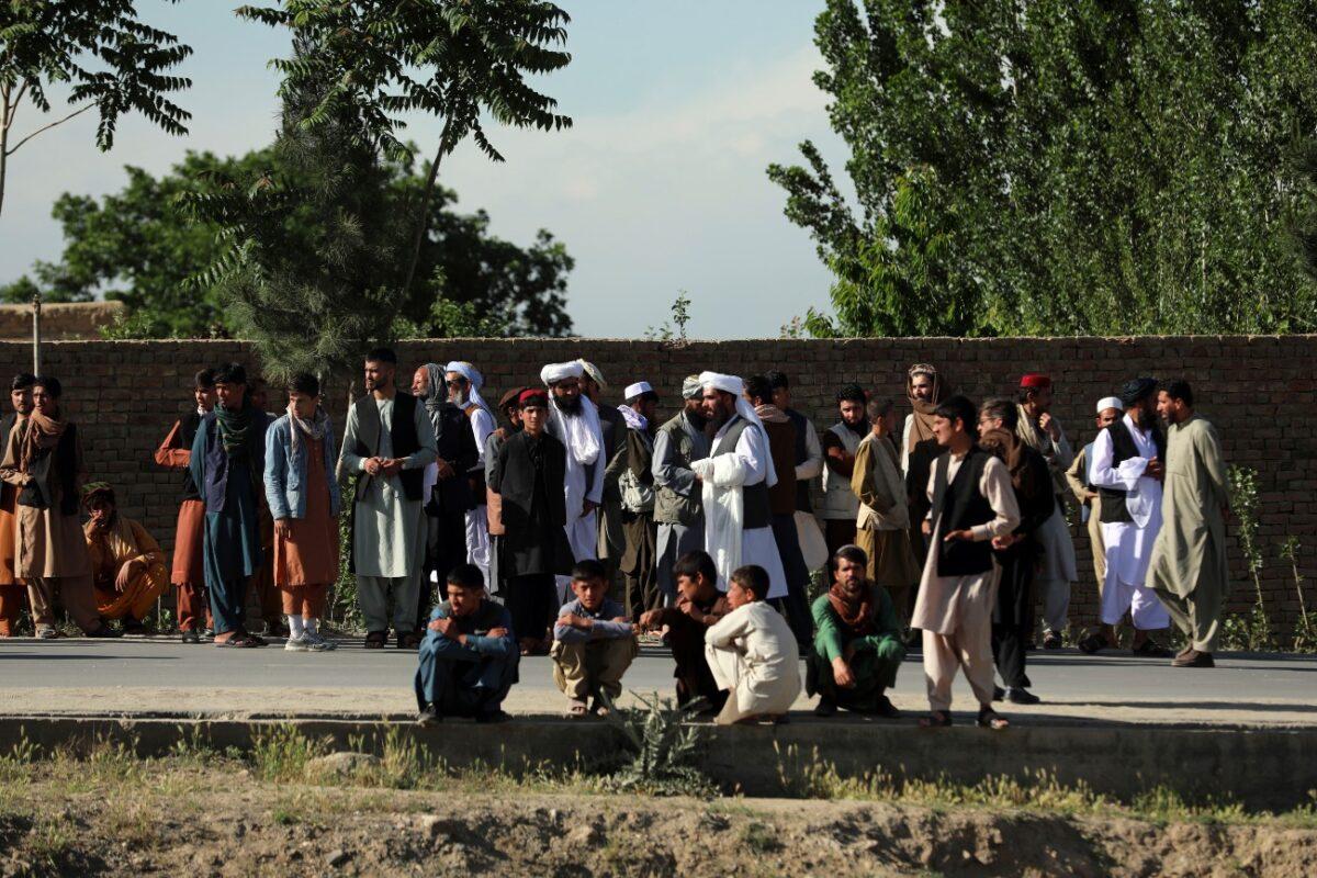 Afghans stand near to mosque after a bomb explosion in Shakar Dara district of Kabul, Afghanistan, on May 14, 2021. (Rahmat Gul/AP Photo)