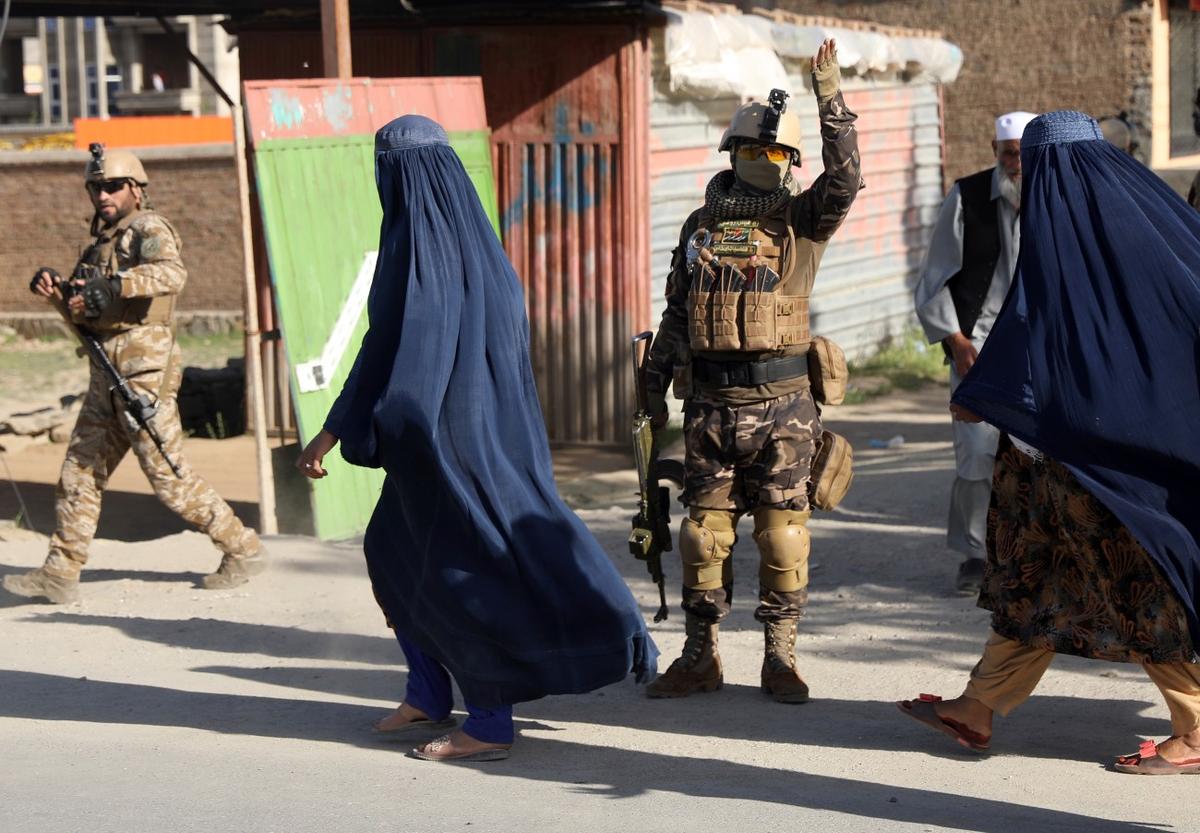 Afghans stand near a mosque after a bomb exploded in Shakar Dara district of Kabul, Afghanistan, on May 14, 2021. (Rahmat Gul/AP Photo)