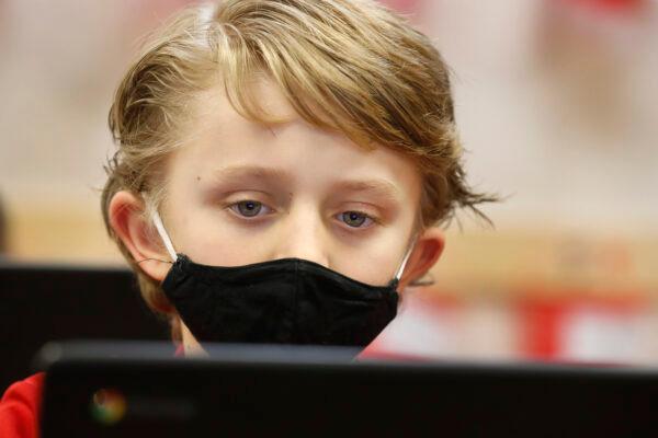  A student wears a mask as he does his work at Freedom Preparatory Academy in Provo, Utah, on Feb. 10, 2021. (George Frey/Getty Images)
