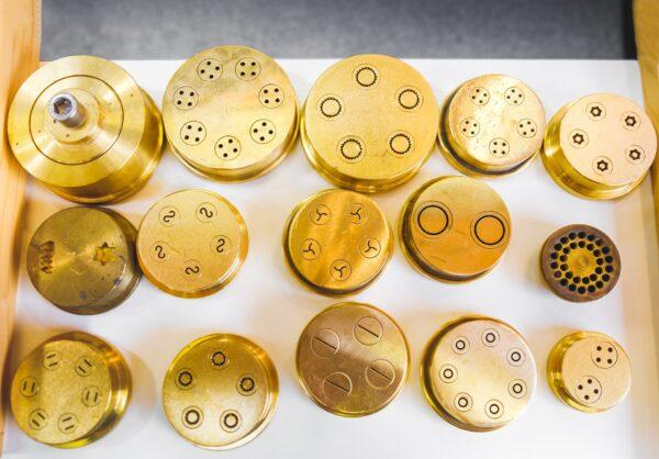 Pasta makers use bronze dies to extrude various shapes. (Luca Lorenzelli/Shutterstock)