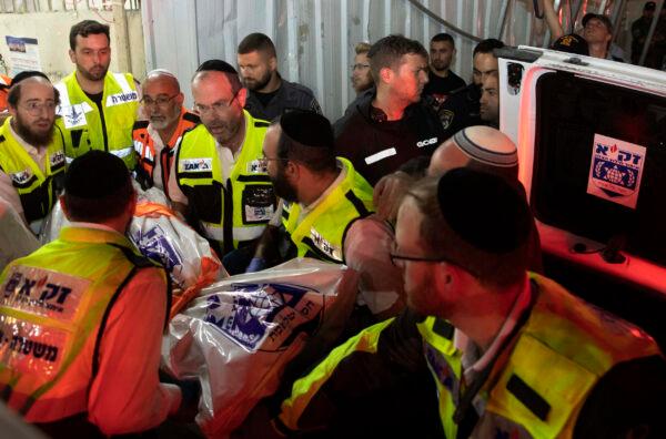Israeli rescue workers carry a body outside a synagogue in Givat Zeev, outside Jerusalem, on May 16, 2021. (Sebastian Scheiner/AP Photo)