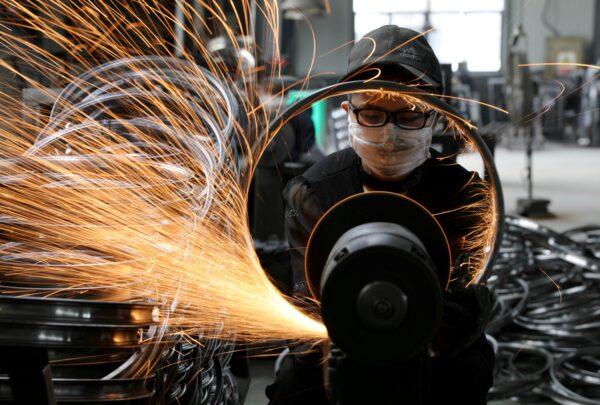A worker welds a bicycle steel rim at a factory manufacturing sports equipment in Hangzhou, Zhejiang province, China, on Sept. 2, 2019. (China Daily via Reuters/File Photo)