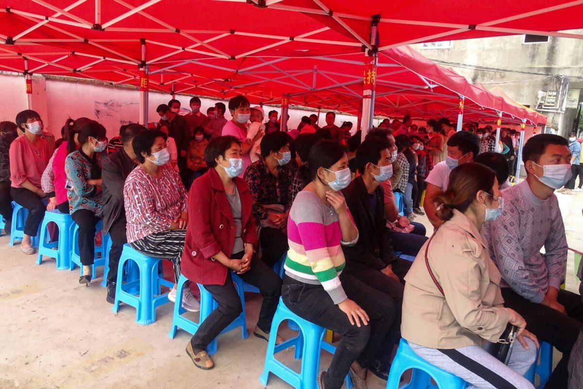 People wait to receive COVID-19 vaccine in Linquan county, Fuyang city, in eastern China's Anhui Province on May 13, 2021. (STR/AFP via Getty Images)