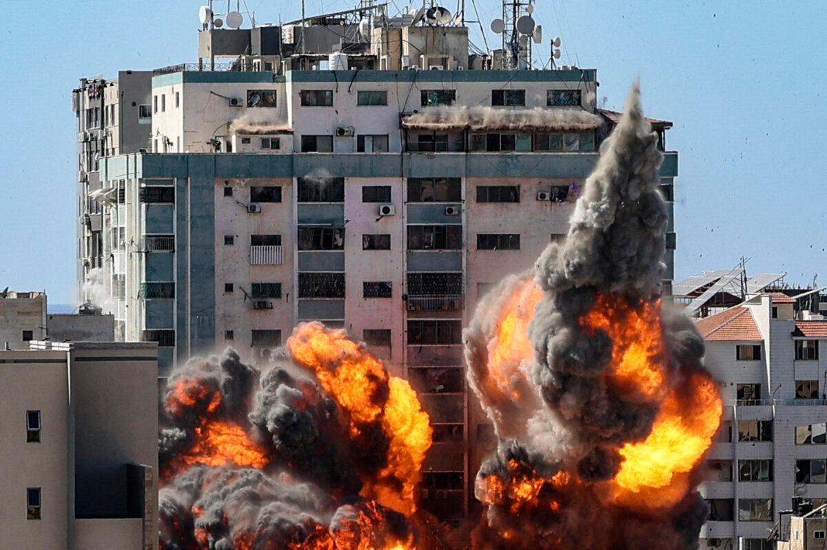 A ball of fire erupts from the Jala Tower as it is destroyed in an Israeli airstrike in Gaza City, controlled by Hamas terrorists, on May 15, 2020. (Mahmud Hams/AFP via Getty Images)