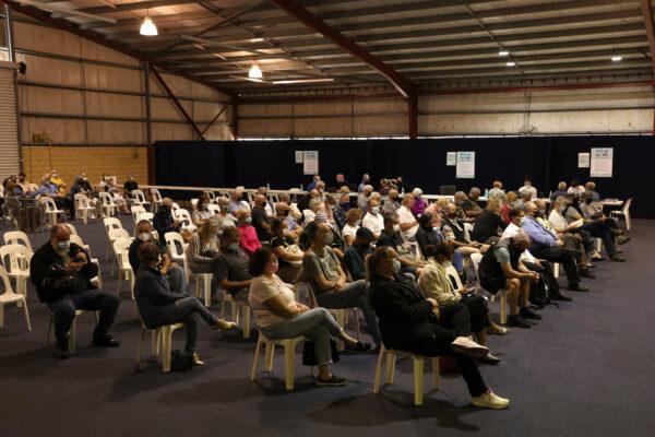 People sit waiting for their AstraZeneca COVID-19 vaccine at the Claremont Showgrounds Covid-19 Vaccination Clinic in Perth, Australia on May 3, 2021. (Paul Kane/Getty Images)