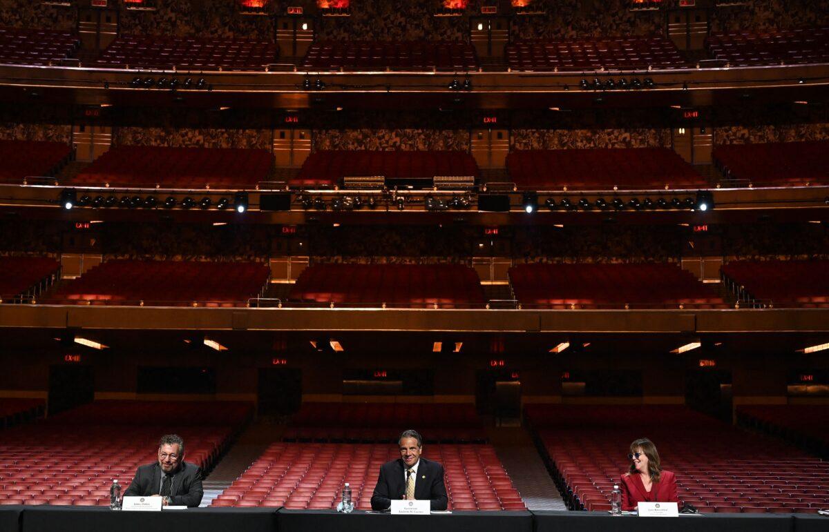 New York Gov. Andrew Cuomo, along with James Dolan (L), executive chairman and CEO of Madison Square Garden Sports, and Jane Rosenthal (R), CEO and executive chair of Tribeca Enterprises, holds a briefing at Radio Music City Hall in New York City on May 17, 2021. (Timothy A. Clary/AFP via Getty Images)