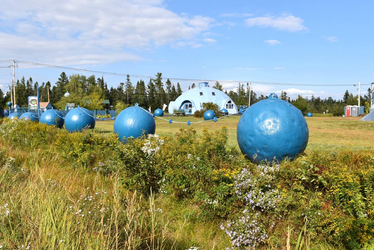 A geodesic dome billed as "the world's largest blueberry" and giant blueberries in a field welcome visitors to the bakery and theme park at Wild Blueberry Land in Columbia Falls, Maine. (Courtesy of Lgokapil/Dreamstime.com)