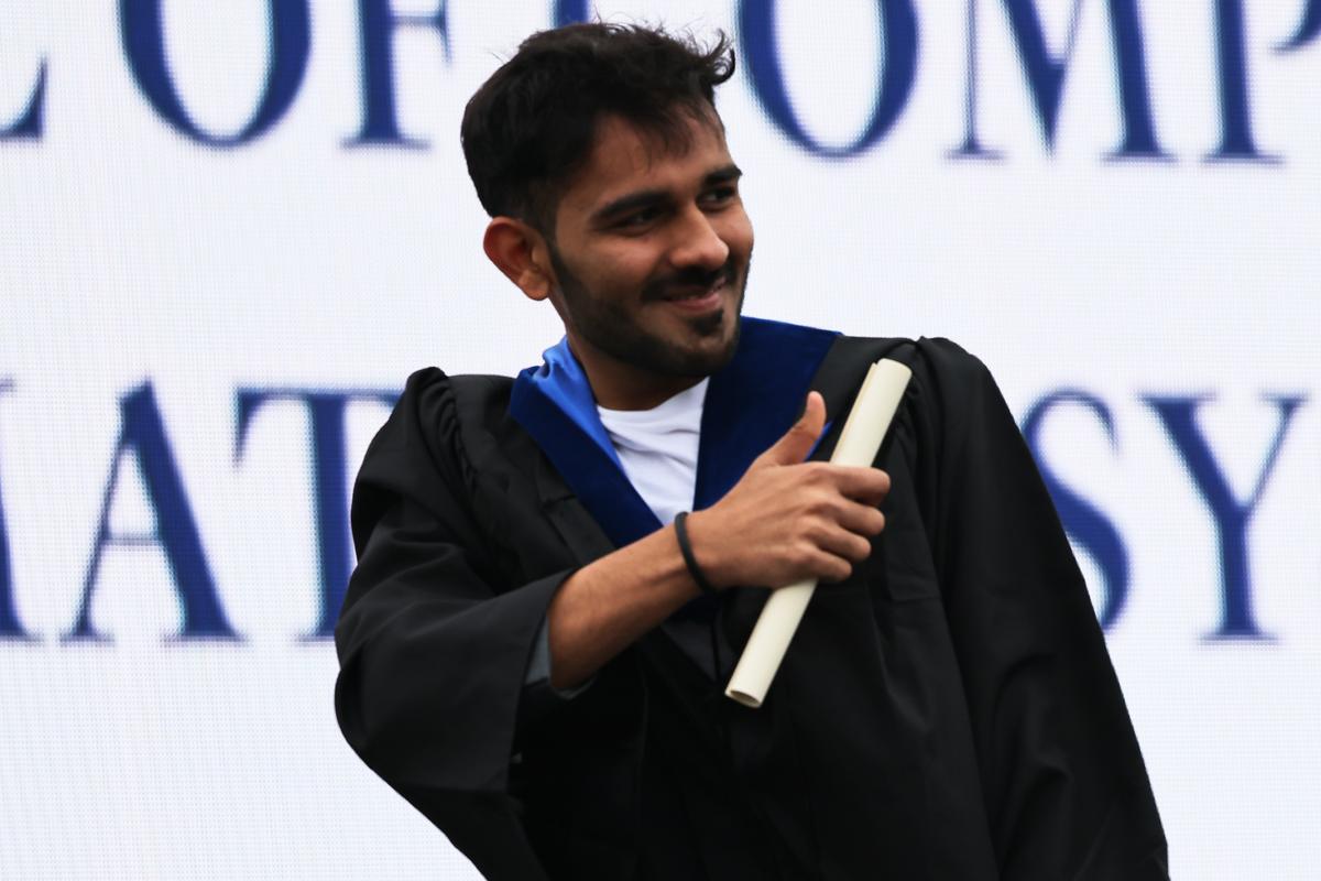 Rahul Shah gives a thumbs-up at a Pace University graduation ceremony at South Street Seaport in Manhattan on May 3, 2021. (Michael M. Santiago/Getty Images)