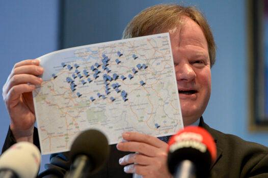 Professor Stefaan Van Gool shows a map of local paediatricians at a press conference after euthanasia laws were expanded for minors in Brussels, Belgium, on February 11, 2014. (Dirk Waem/AFP via Getty Images)