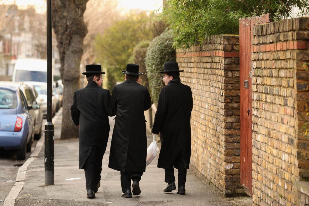 Jewish men walk along the street in the Stamford Hill area of north London on Jan. 19, 2011. (Oli Scarff/Getty Images)
