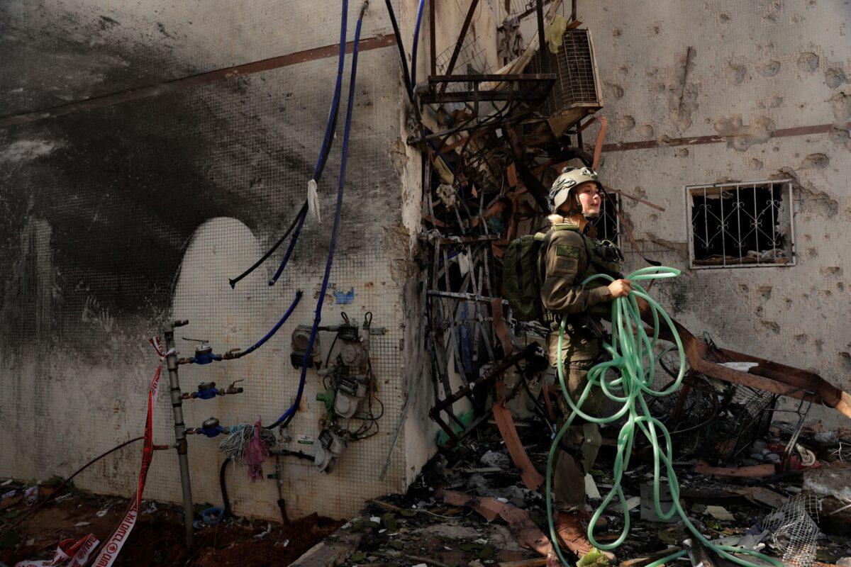 An Israeli soldier inspects damage to an apartment in a residential building after it was hit by a rocket fired from the Gaza Strip, in Ashdod, southern Israel, on May 17, 2021. (Maya Alleruzzo/AP Photo)