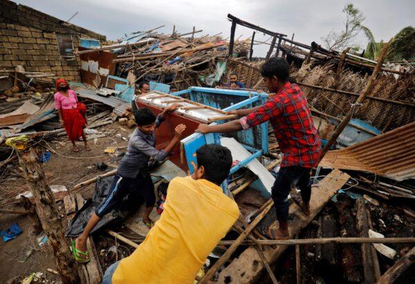 People salvage their belongings from a damaged house after cyclone Tauktae hit, in Navabandar village, in the western state of Gujarat, India, on May 18, 2021. (Amit Dave/Reuters)