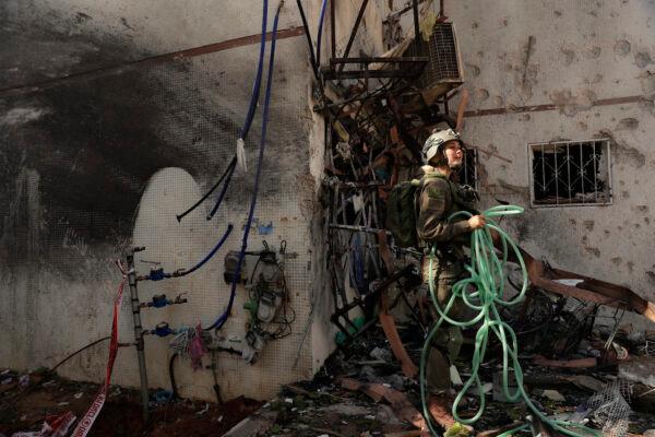 An Israeli soldier inspects damage to an apartment in a residential building after it was hit by a rocket fired from the Gaza Strip, in Ashdod, Israel, on May 17, 2021. (Maya Alleruzzo/AP Photo)