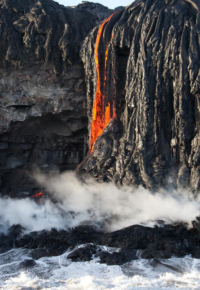 Red hot lava enters the ocean on the Big island, Hawaii. (Juancat/Shutterstock)