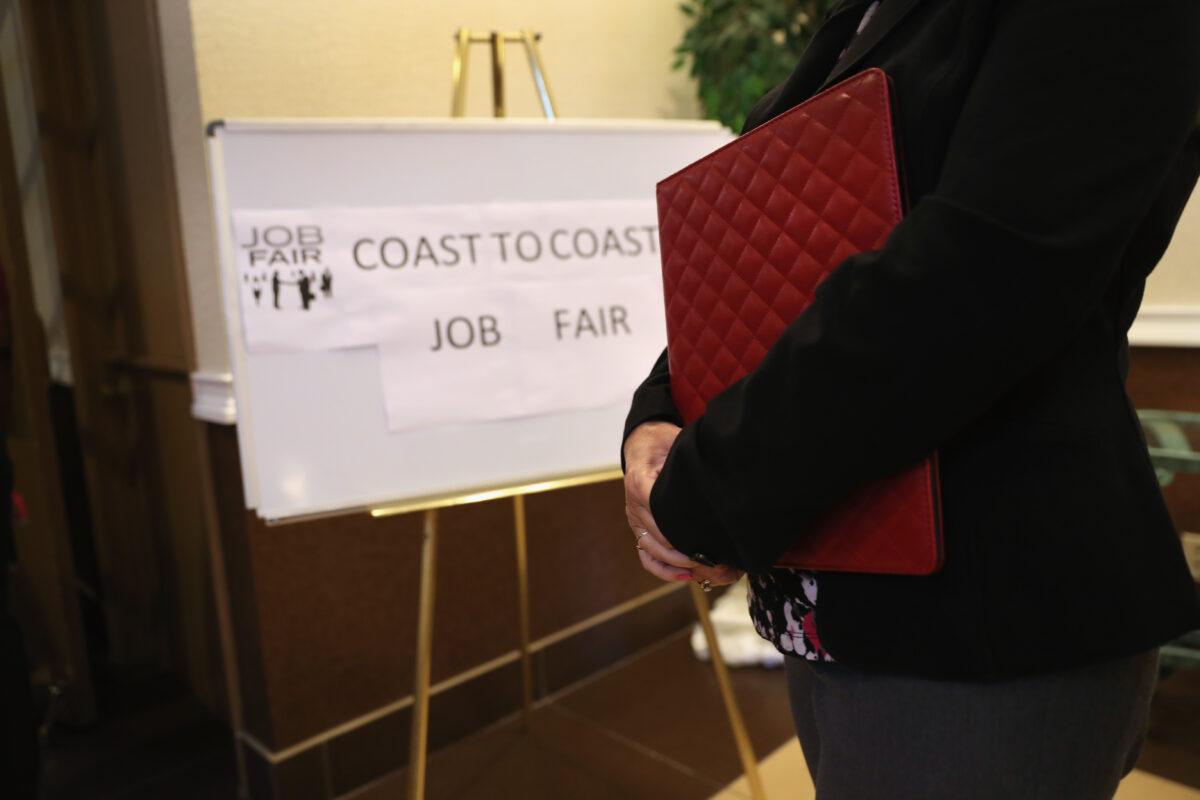 A woman waits to meet potential employers at a job fair in Hartford, Conn., in a file photograph. (John Moore/Getty Images)