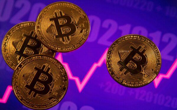 A representation of virtual currency Bitcoin is seen in front of a stock graph in this illustration, on March 15, 2021. (Dado Ruvic/Reuters)