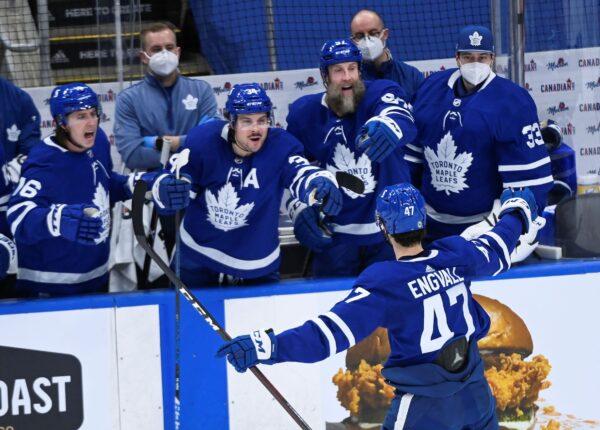 Toronto Maple Leafs forward Pierre Engvall (47) celebrates his goal against the Montreal Canadiens with Mitchell Marner (16), Auston Matthews (34), Joe Thornton (97) and David Rittich (33) during the second period of an NHL hockey game in Toronto, Canada, on May 8, 2021. (Nathan Denette/The Canadian Press via AP)